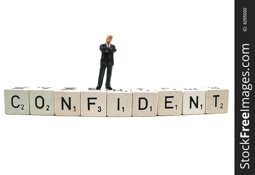 A confident businessman standing on the word confident