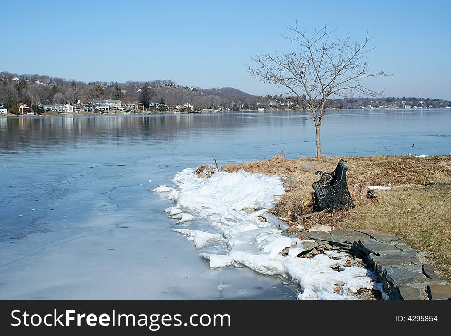 Old Empty Bench On A Frozen Lake