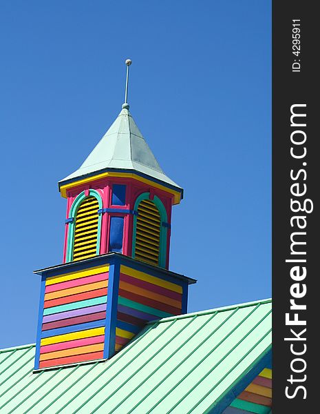 Colorful wooden slatted tower against a blue sky. Colorful wooden slatted tower against a blue sky