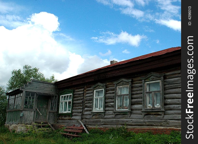 A typical shaky old wooden house in a Russian village. A typical shaky old wooden house in a Russian village.