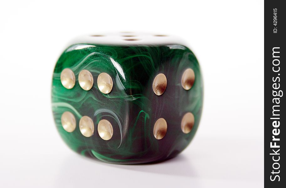 Beautiful green dice with golden dots, for successful gambling.