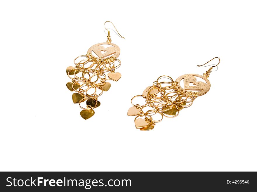 Golden ear-rings on the white isolated background