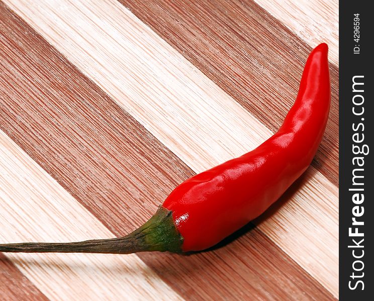 Fresh red hot chili pepper on a wood board