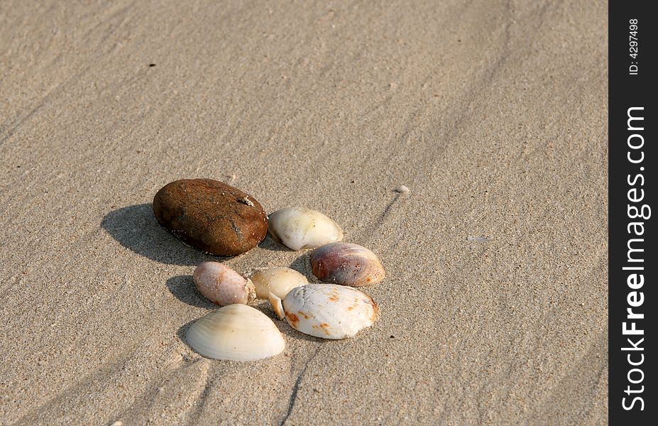 Pebbles on the sand on a hot sunny day