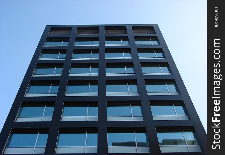 Tall office building with a blue sky as a background