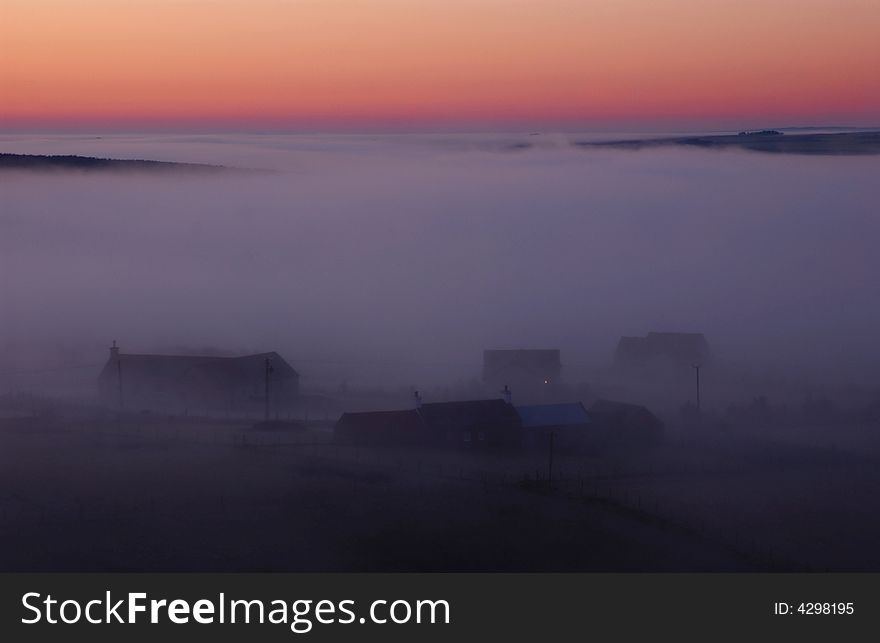 Fog coming in from the sea in a small village