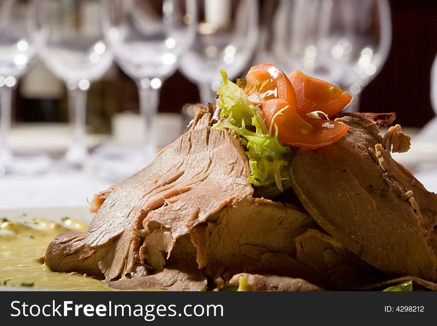 Beef meat with tomatoes and greens on a plate