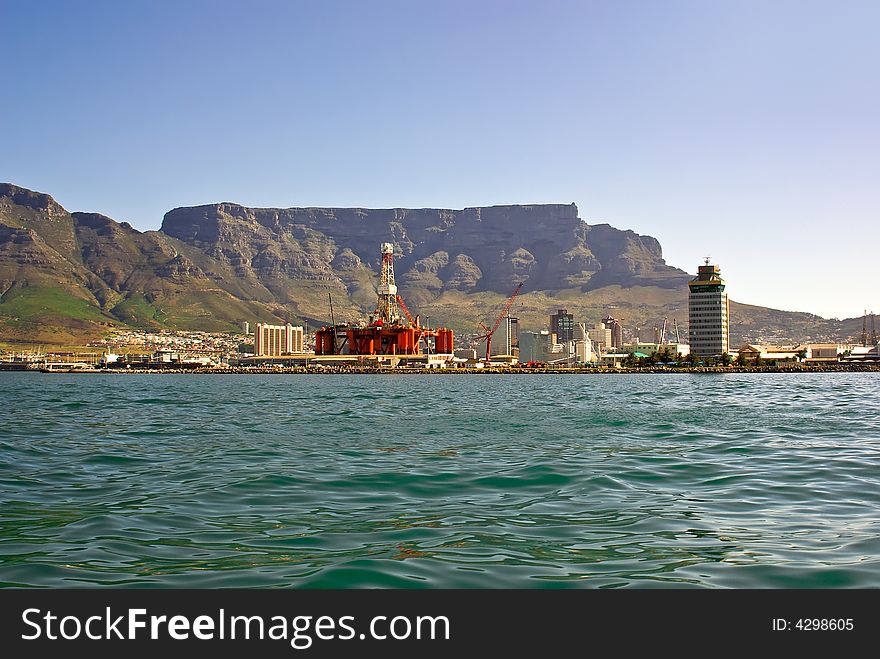 Panorama of city of cape town from the bay oil rig near tower building against table mountain