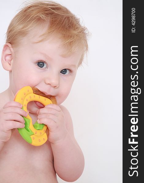 Portrait of the beautiful fair-haired boy with a toy in hands. Portrait of the beautiful fair-haired boy with a toy in hands