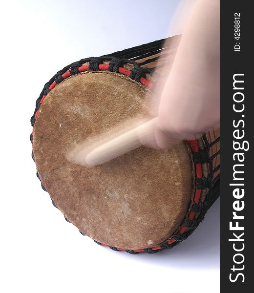 Playing African kenkeni drum with stick. Playing African kenkeni drum with stick