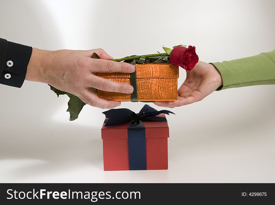 An exchange of gift between a couple, businessmen/woman. An exchange of gift between a couple, businessmen/woman