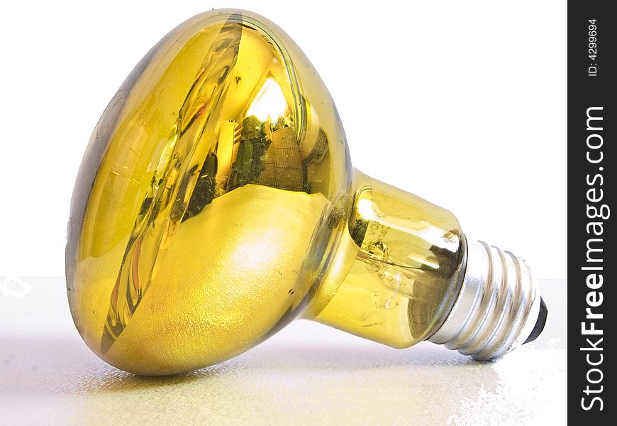 Yellow reflective spot light bulb against a white background