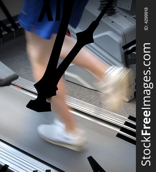 Young male running on treadmill in gymnasium. Young male running on treadmill in gymnasium