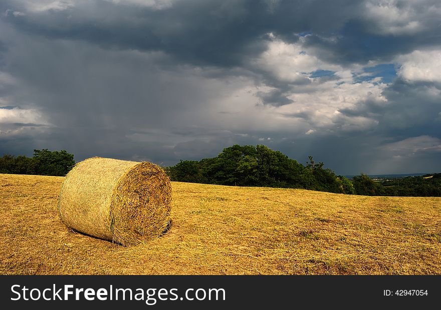 Bale of hay with stormy background