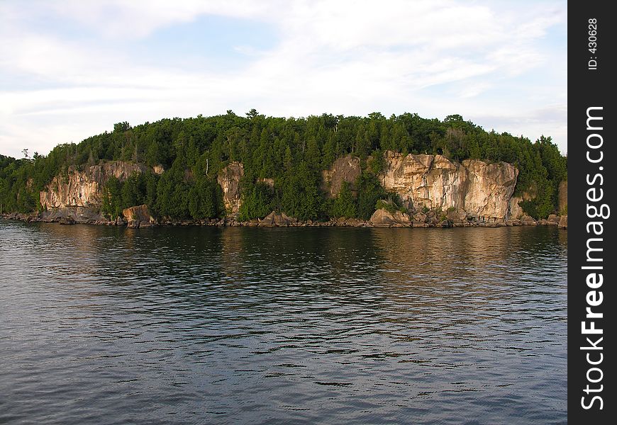 Island of rock on lake. Island of rock on lake.