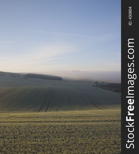 Ploughed field with fog in the distance. Ploughed field with fog in the distance