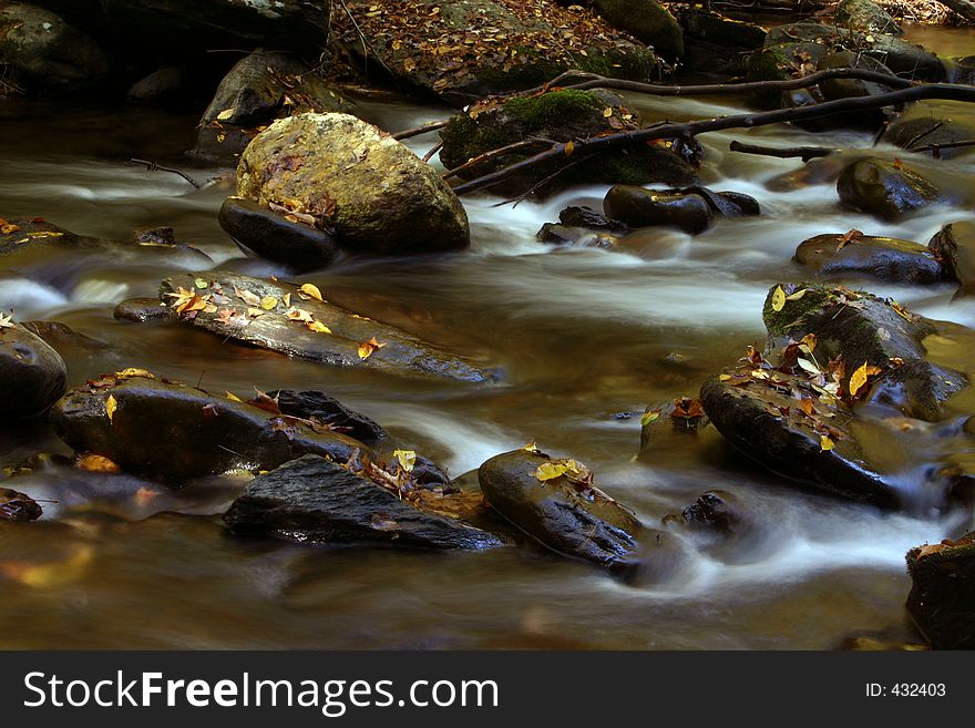 Flowing stream in fall slow exposure. Flowing stream in fall slow exposure