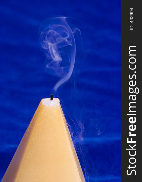 An abstract image on a candle and swirling smoke. An abstract image on a candle and swirling smoke