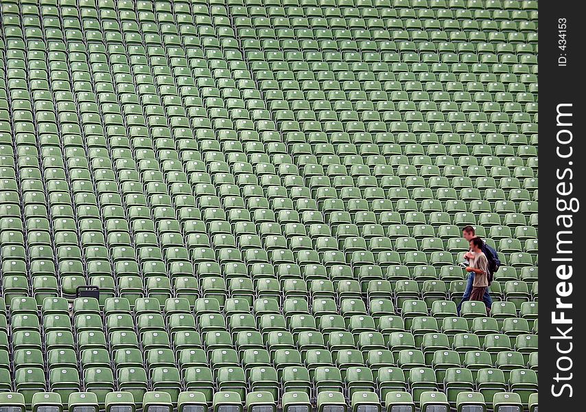 Green stadion seats in Bregenz/Austria with blure persons