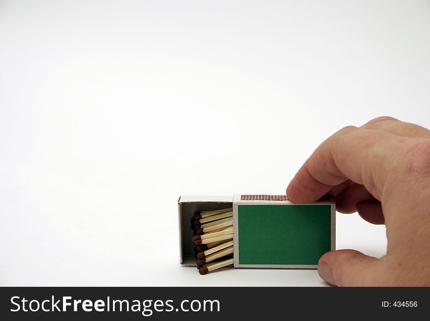 Matches in a green box with hand