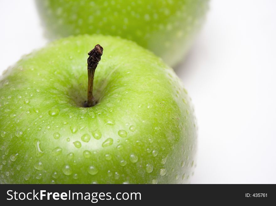 Raindrops on two delicious green apples. Raindrops on two delicious green apples.