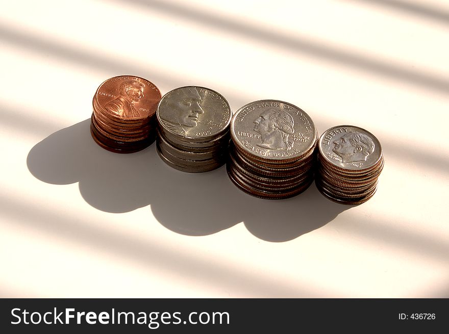 Stacked pennies, nickels, quarters and dimes. Stacked pennies, nickels, quarters and dimes