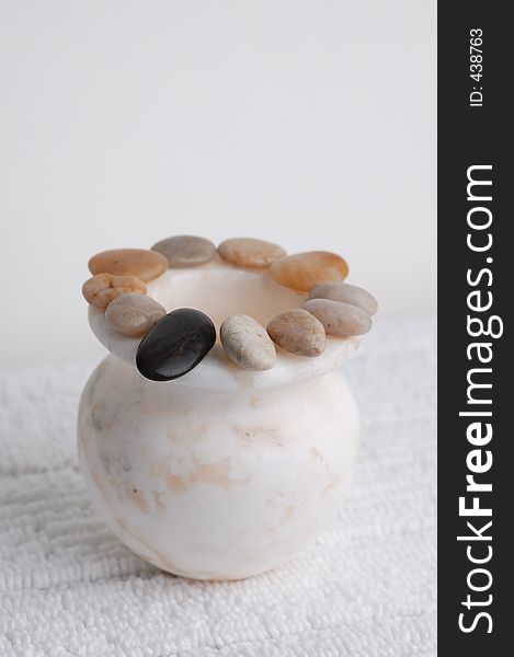 Circle of stones on a marble vase