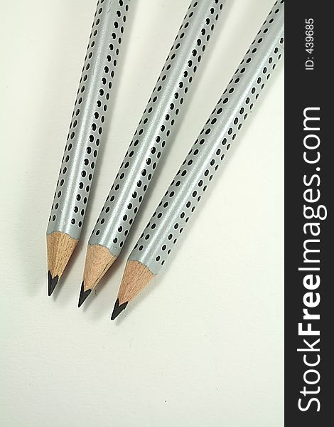 Three grey pencils
