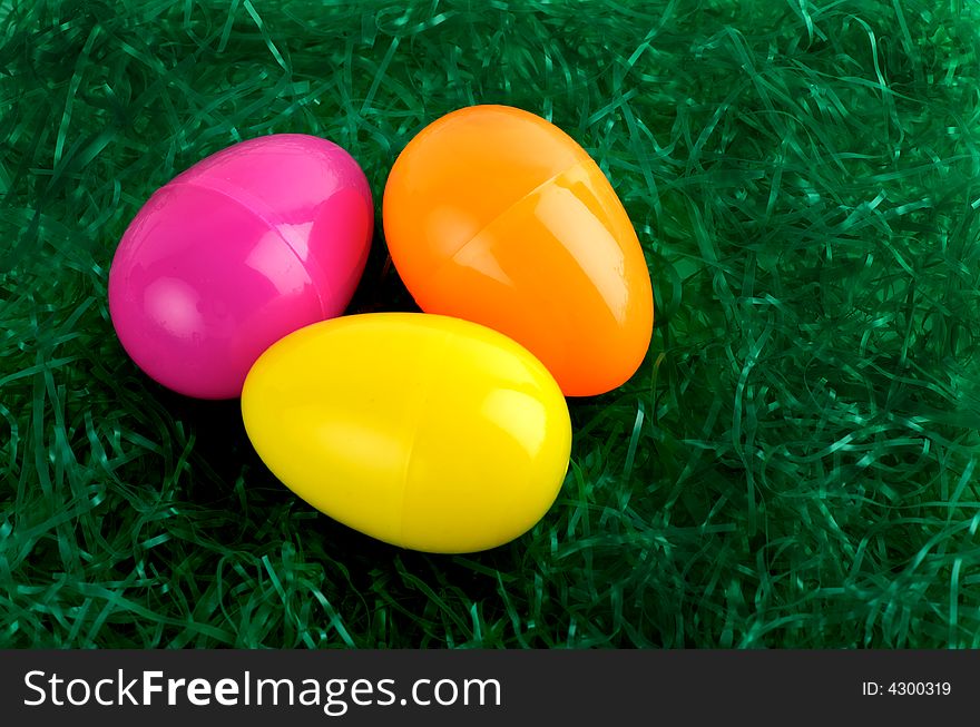 Colorful Easter eggs on green straw