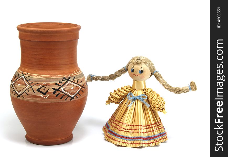 Clay jug and straw doll isolated on a white background