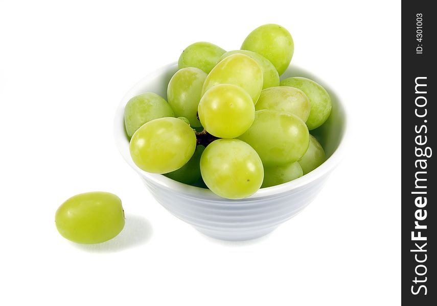 Green Grapes in a small white bowl isolated on white background. Green Grapes in a small white bowl isolated on white background.