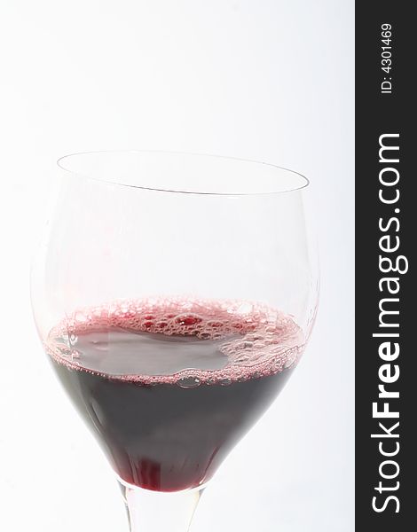 Red wine in a glass.  White background. Red wine in a glass.  White background