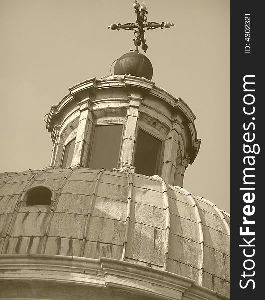 Church cupola with cross, looking up view, sepia image