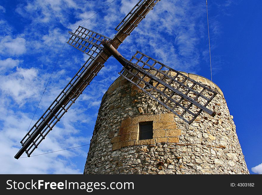 An image of a classic mill with a blue sky