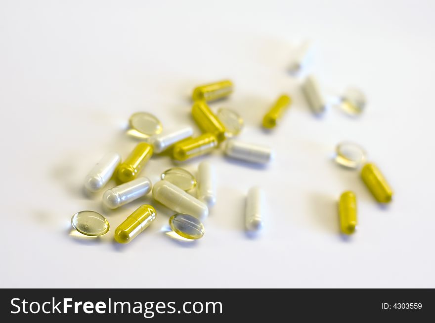 Different kind of pills on white background