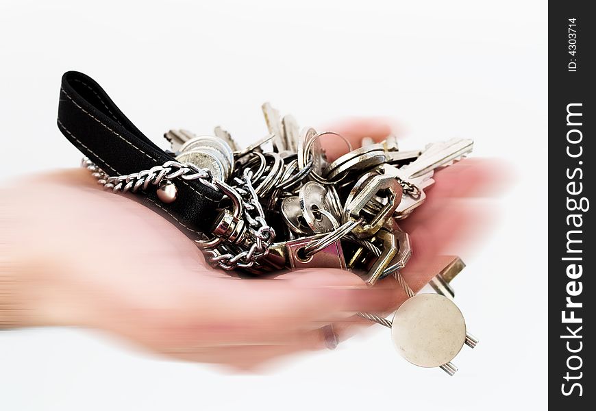 Hand in motion holding many keys. Hand in motion holding many keys