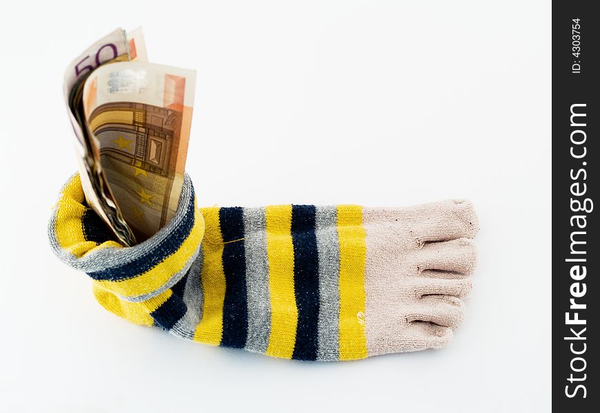 Money saved at home in yellow-black-grey sock isolated. Money saved at home in yellow-black-grey sock isolated