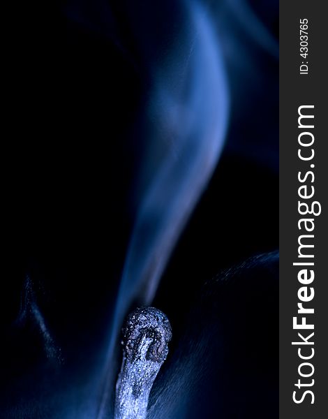 Match with smoke isolated in dark background