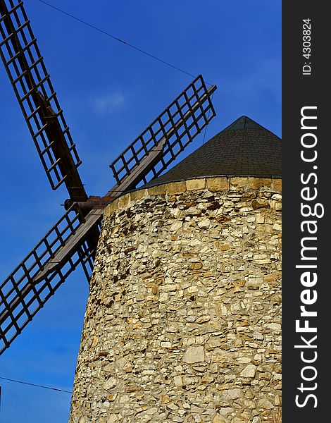 An image of a classic mill with a blue sky