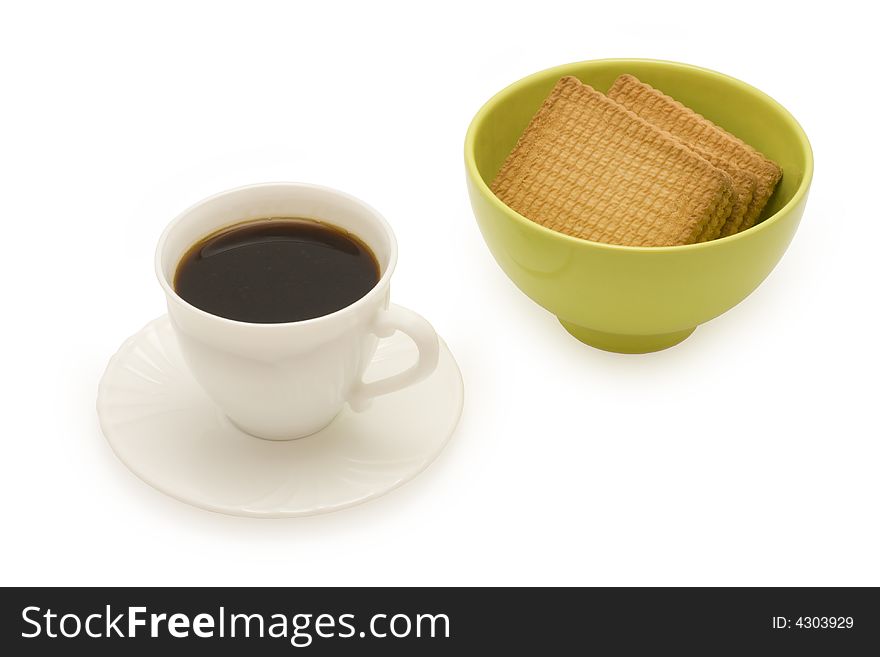 A cup of coffee and a candy dish of cookies isolated on white. A cup of coffee and a candy dish of cookies isolated on white