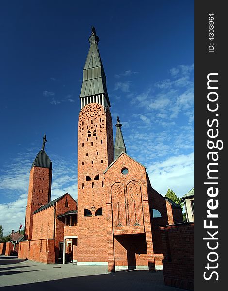 Red church and cirrus sky