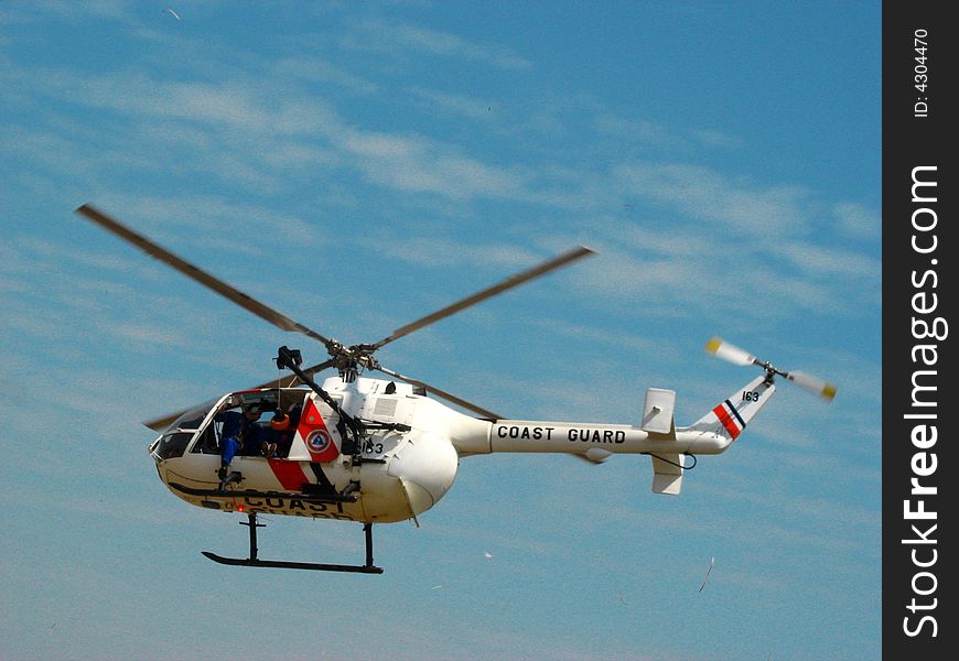 This is an mbb bo 105 helicopter of the philippine coast guard performing a search and rescue demo during an airshow in clark field, pampanga, the philippines.