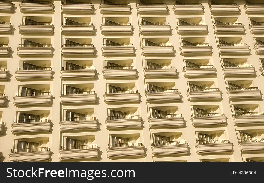 Rows of identical balconies on a white high rise resort hotel. Rows of identical balconies on a white high rise resort hotel