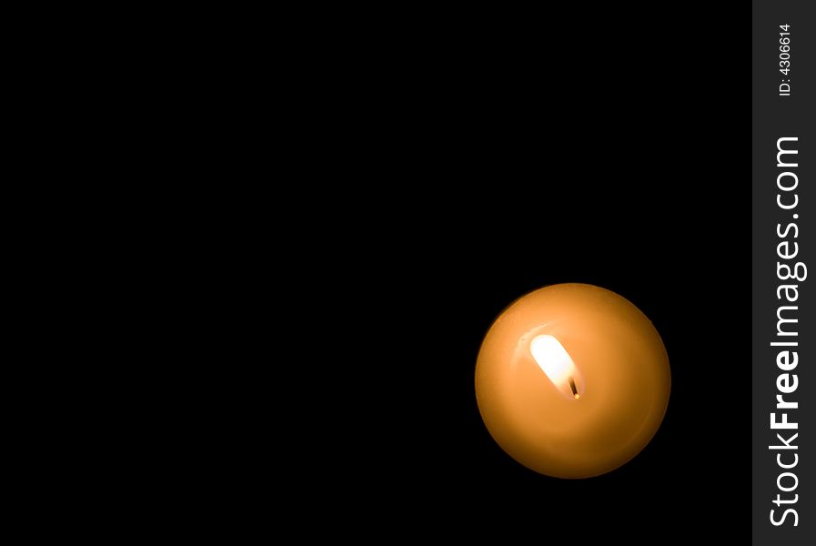 Solitary candle burning in a corner. Solitary candle burning in a corner