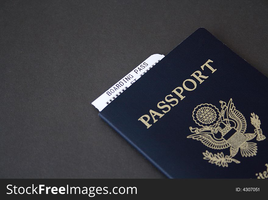 Passport with boarding pass on a dark gray background. Passport with boarding pass on a dark gray background