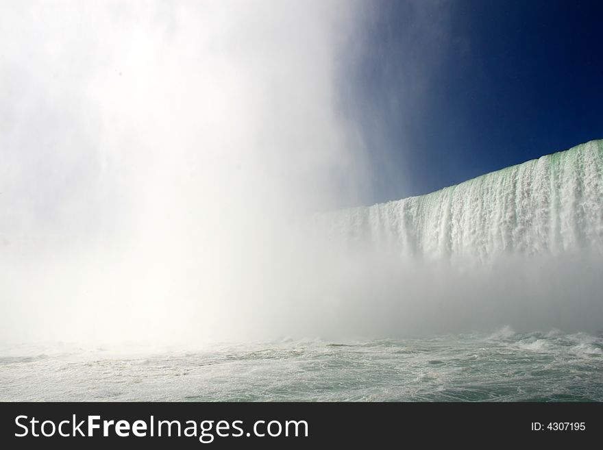 Dramatic river level view of the Horseshoe Falls at Niagara. Dramatic river level view of the Horseshoe Falls at Niagara.