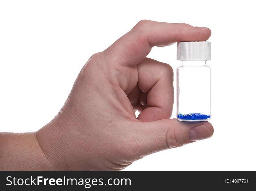 Man's hand holds a vial with blue crystal. Isolated on white [with clipping path]. Man's hand holds a vial with blue crystal. Isolated on white [with clipping path].
