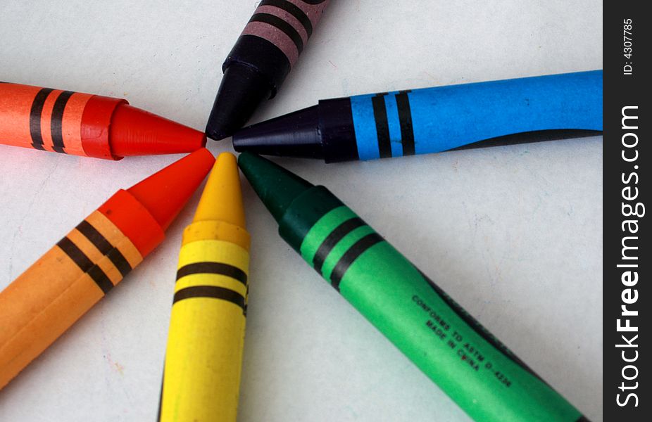Colorful assorted crayons on a white background