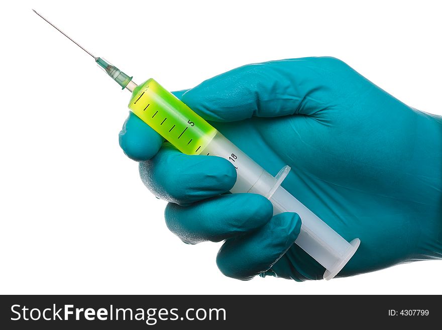 The man's hand in a glove holds syringe with green fluorescent liquid. Isolated on white [with clipping path]. The man's hand in a glove holds syringe with green fluorescent liquid. Isolated on white [with clipping path].