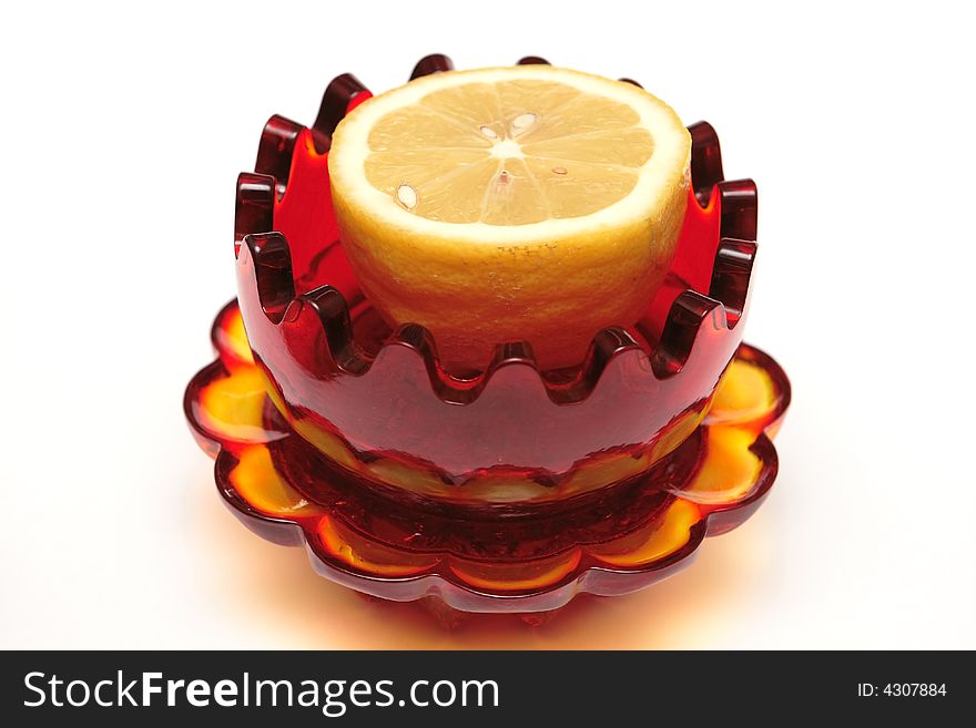 Red glass souvenir with lemon on the white background. Red glass souvenir with lemon on the white background